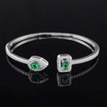 Irregular S925 silver open bangle with emerald and pear cut green gemstones and pavé accents - Green Asymmetric Gem Style