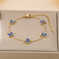 Detail of five butterfly pendants on golden titanium steel chain with blue enamel - Dark Blue (KB187207-BI)