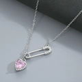 Macro view of silver safety pin necklace featuring a sparkling pink heart zircon pendant - Silver Pink