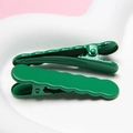 Detail view of two dark green wave-shaped metal hairpins on a heart-shaped tray - Christmas Green