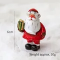 Miniature Santa Claus figurine holding a green gift box for Christmas desk decoration - Standing Santa with Gift Box