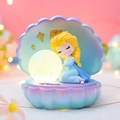 Charming princess shell night light with warm glowing orb and golden star accents - Blue Shell Lamp