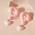 Detail of pink resin heart earrings featuring a unique 3D question mark design on stone - Pink