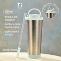 Detail of 830ml pure titanium vacuum cup with mint green lid and integrated straw - 830ml / Cyan White
