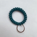 Deep teal spiral spring keychain with durable matte plastic coil and silver metal ring - Cyan