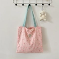 Detail of pink floral quilted tote bag with light blue straps and a cute sheep pendant - Bouquet Rabbit