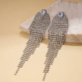 Close-up of luxury geometric silver fringe earrings with sparkling zircon tassels - Silver