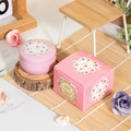 Pink floral scented candle in metal tin with matching gift box on wooden decor - Jasmine