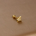 Detailed macro view of golden star-shaped stud earring with micro-inlaid cubic zirconia - Four-pointed Star / Gold