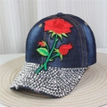 Detail view of denim baseball cap with rose embroidery and rhinestones on the brim - Style 47-Deep Blue Denim Heavy Rose