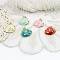Detailed view of colorful seashell pendants with crystals on white lace and feather backdrop - Zircon Scallop 18*19.7mm