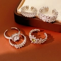 Macro shot of silver zircon flower open rings on dark brown leather background - Silver 5-Piece Set