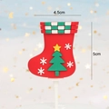 Detail view of a red Christmas stocking cake topper with 3D tree and star patterns - Soft Glue Christmas Stocking
