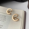 French vintage matte gold geometric twisted stud earrings on an open book - Gold Geometric Twisted Stud (E070)