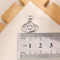 Detailed macro view showing a silver Evil Eye pendant with clear zircon inlay and size scale - E0011S