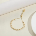 Detail of adjustable sliding gold clasp and alternating pearls on a 14K beaded bracelet - 5mm