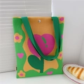 Detailed knit texture of green floral tote bag with pink heart and silver button closure - Tulip Green