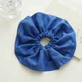 Detail of oversized blue denim fabric scrunchie with soft ruffled texture for women - Blue