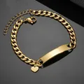Close-up of golden stainless steel Cuban ID bracelet with curved plate and heart charm - Heart Pendant Bracelet-Gold