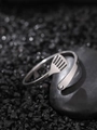 Macro detail of adjustable stainless steel glowing ring on dark textured stones - NR310 Broom
