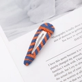 Handmade knitted hair clip with blue and orange stripes on stylish magazine background - Teardrop / Blue Orange