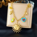 Gold charm necklace featuring sun face, blue heart and evil eye pendants on jewelry box - Sun Face and Blue Heart Style (N3536)