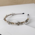Macro detail of luxury crystal stones and white pearls on a light grey thin headband - Style SJ008 / Square Gray