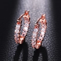 Luxury rose gold earrings with square-cut cubic zirconia on a black leather background - Rose Gold