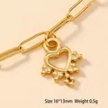 Detailed macro view of a 16x13mm hollow gold heart pendant on a paperclip chain - Beaded Heart (68)
