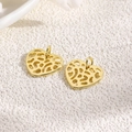Macro shot of 18k gold-plated heart charms with hollow design on stone texture background - Golden Mesh Hollow Heart (ZYN-DMK769G)