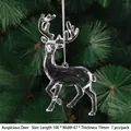 Clear acrylic reindeer Christmas ornament with silver string on green pine branch - Lucky Deer