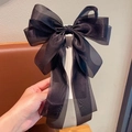 Handheld view of a large black organza bow hair clip for girls in elegant 3D style - 054 Long Streamer Bow Spring Clip [Black]
