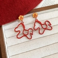 Detail der roten Pferde-Ohrringe mit Gold-Finish und Fu-Glücks-Schriftzeichen - Hohles Pferd Design