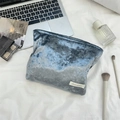 Close-up of a blue velvet cosmetic bag with Suzakka label on a lifestyle desk setup - Dark Green