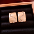 Close-up of 18K gold plated rectangular earrings with S-curve zircon inlay details - Gold / Gold