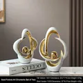 Abstract white ceramic vases with gold interior hollow rings, set of 2 modern sculptures - Turning Luck Abstract Sculpture Set - 2 Pieces