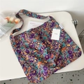 Detailed view of canvas tote bag with purple floral pattern on a lifestyle desk setup - Yellow Purple Floral