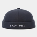 Close-up of Stay Wild embroidery on black cotton docker hat with visible fabric texture - Adjustable / Dark Gray