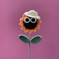 Handmade crochet sunflower with orange petals, sunglasses and a mini hat on pink background - Cartoon Sunflower Light Yellow