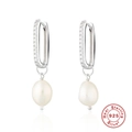 Detailed close-up of 925 sterling silver earrings with baroque pearls and zircon stones - Platinum