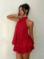 Detail of red halter neck dress with layered ruffle hem and backless chiffon design - Red