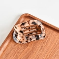 Macro shot of tortoiseshell acetate hair claw clip with leopard pattern on wooden tray - Round Claw / Beige