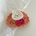 Close-up of handmade crochet flower hair clip with cute white rabbit and pink base detail - Crochet-Orange Rabbit