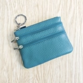 Teal genuine leather coin purse with triple zipper pockets and metal keychain on wood - Light Blue