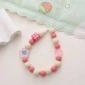 Detailed view of pink and cream beaded phone charm with red checkered bead and floral pendant - Checked Square Pink Plum Blossom Style (K1686)