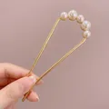 U-shaped hair pin in golden metal finish with five round pearls for hair styling - Curved Pearl Gold