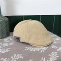 Detailed shot of the cotton duckbill beret side with fashion patch and adjustable design - Beige