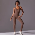 Detailed view of the racerback design and elastic fabric on a seamless yoga bodysuit - Brown