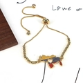 Gold adjustable beaded bracelet with Venezuela map charm featuring yellow blue red enamel - Gold