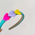 Detail of teal sponge headband featuring matte pink, purple and yellow 3D hearts - Turquoise Hoop